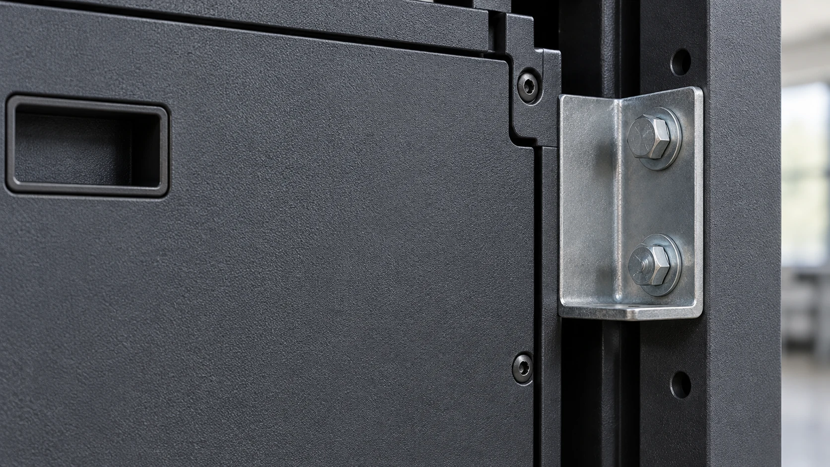 Matte-coated LED cabinet back beside a silver metal bracket and two bolts